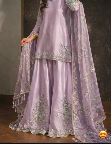 Elegant lavender silk sharara suit with intricate silver embroidery and a matching net dupatta.