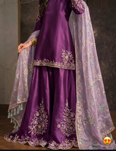 Purple silk sharara suit with intricate silver embroidery and a sheer lavender floral dupatta.