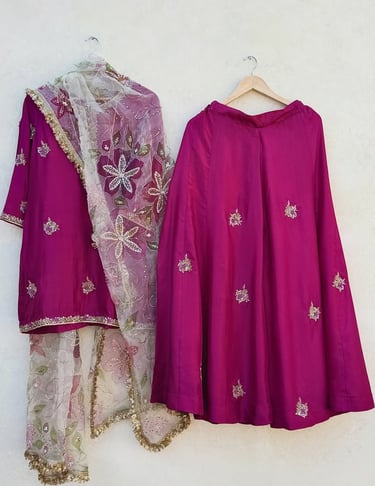 Elegant magenta silk lehenga choli with floral embroidered organza dupatta for weddings.