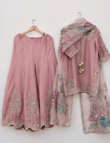 Elegant dusty pink lehenga choli with intricate floral embroidery and a sheer dupatta.