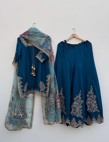 Teal blue embroidered lehenga choli and net dupatta for wedding and festive wear.