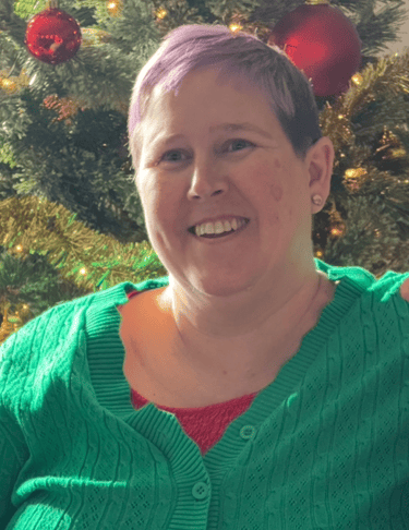Woman With Green Shirt Christmas Tree Behind Her