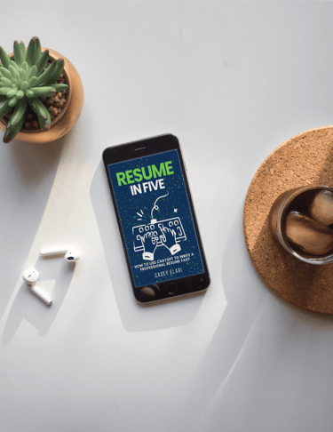 a cell phone with a resumee on it and a cup of coffee