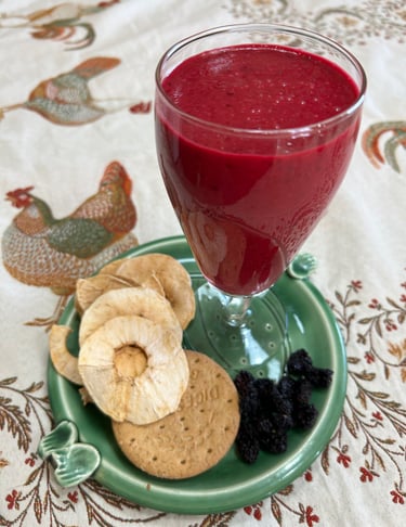 beetroot yoghurt drink on plate with dried fruit on a tablecloth with a chicken design