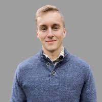 a man in a blue sweater and a white shirt