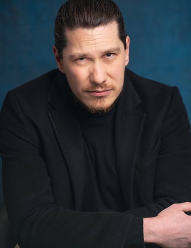 a man in a black suit and a black jacket