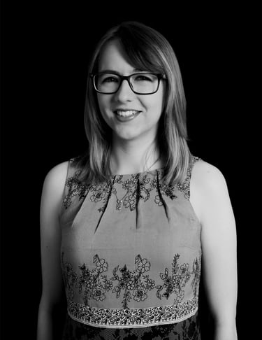 A black and white photo of Eloise, a woman in glasses and a dress.