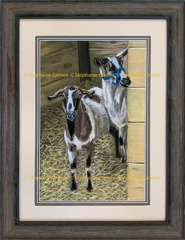 Framed pastel drawing of two goats standing on straw in a barn by artist Stephanie Grimes.