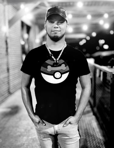 A man in a cap poses at night.