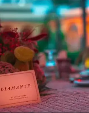 a table setting with a menu card and a candle