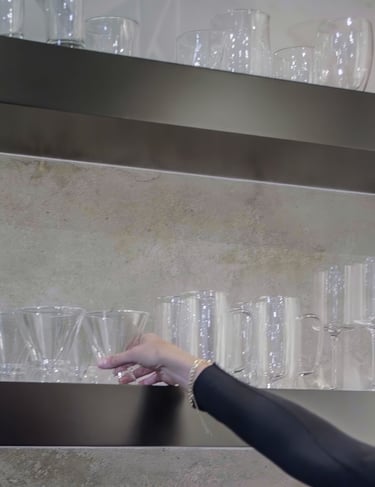 a woman is holding a glass of wine