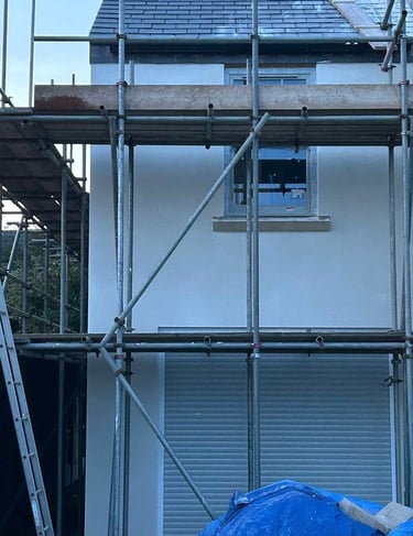 Team applying smooth render to the outside of a residential property.
