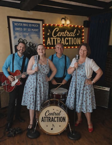 Central Attraction 1940s vintage band performing with 50s rock and roll style attire and instruments.
