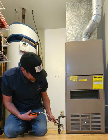 Felix checking for gas leaks on an older furnace