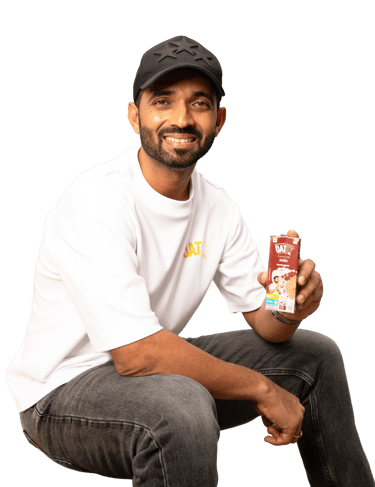 Ajinkya Rahane holding Oatey Premium Oat & Millet Milk – Plant-Based Dairy-Free Drink in India