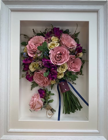 a bright pink side view preserved wedding bouquet in a frame