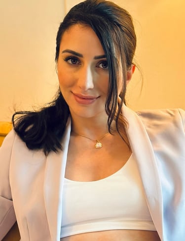 a woman in a white top and a white jacket
