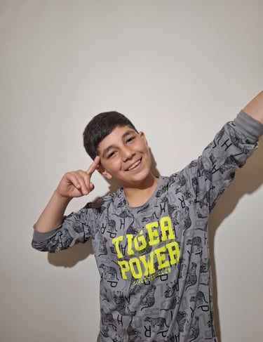 a young boy with a gray shirt and a black shirt