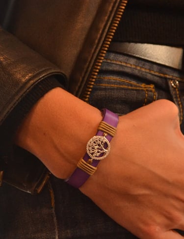 a woman's wrist wearing a purple bracelet