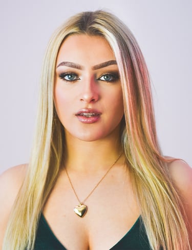 a woman with blonde hair and a green dress
