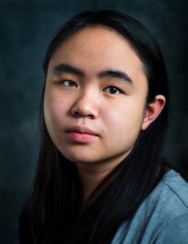 a woman with long hair and a gray shirt