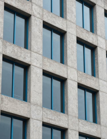 Architecture photography of a modern concrete building facade with cerulean blue window frames, North American / US.