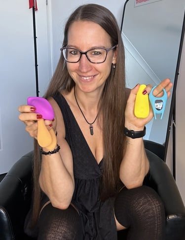 Pleasurelit Patricia holding the moment condoms pleasure toys. 