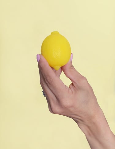 a person holding lemon soap