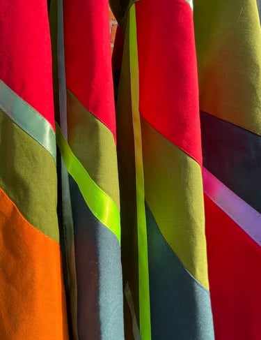 Close-up of vibrant multicolored fabric panels with neon accents.