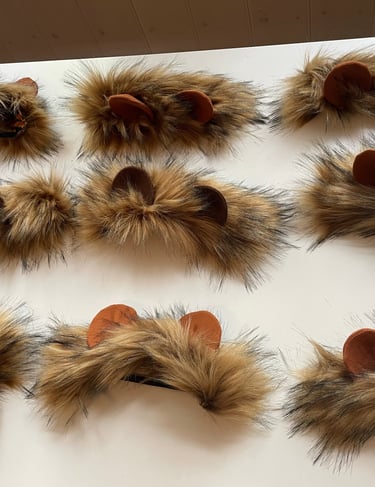 Handmade brown faux fur lion headbands with rounded ears for animal costumes.