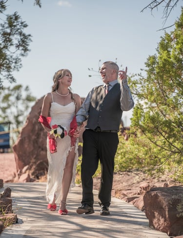 a man and woman walking down a path
