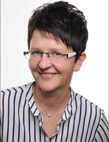 a woman with glasses and a necklace on her neck