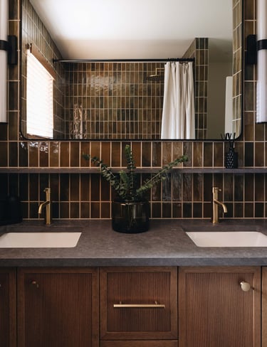 a bathroom with a large mirror and a potted plant