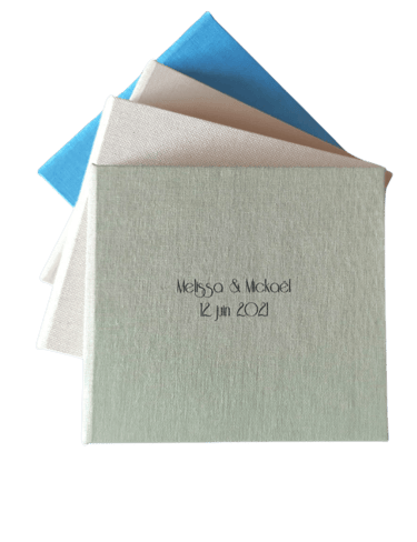 a stack of three different colored envelopes