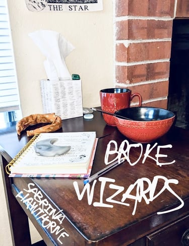 A photograph of a side table, cluttered with mundane & magical items. Written over the photo are the title and author’s name.