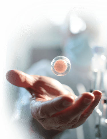 A human hand reaching toward a floating cell for stem cell therapy in mexico.