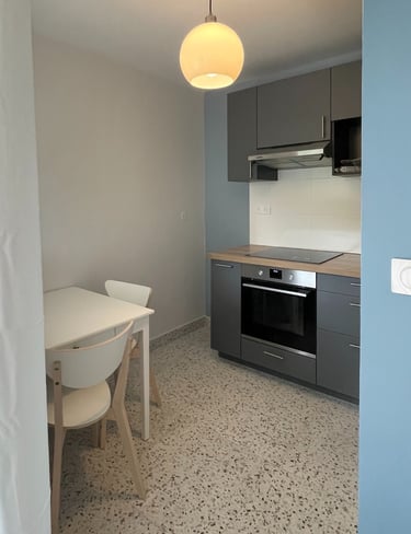 a kitchen with a table and chairs 