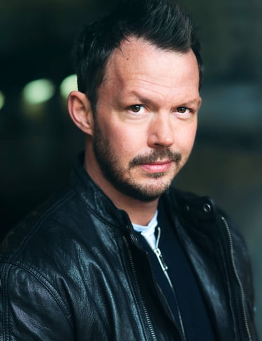 a man with a beard and a leather jacket