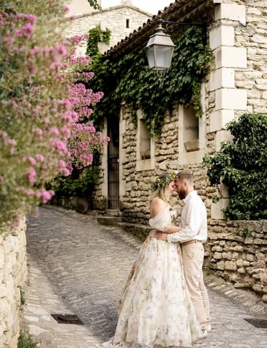 Editorial Provence photographer – couple forehead to forehead in floral street of Gourdon