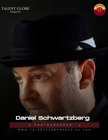 Portrait of photographer Daniel Schwartzberg wearing a black fedora for Talent Globe Magazine.