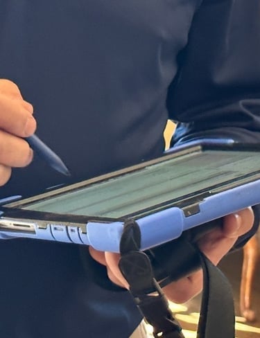 "Person using a tablet during a home visit, highlighting the difference between inspection and home 