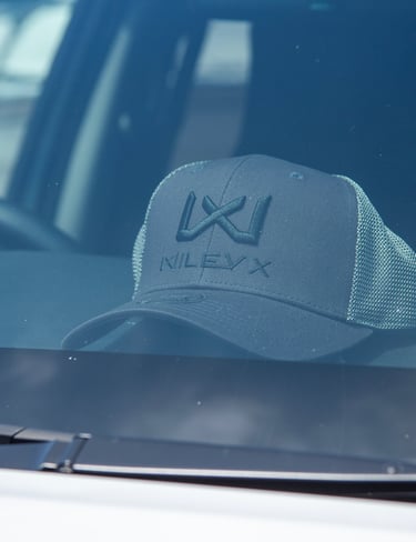 Wiley X Hat in the front of a car