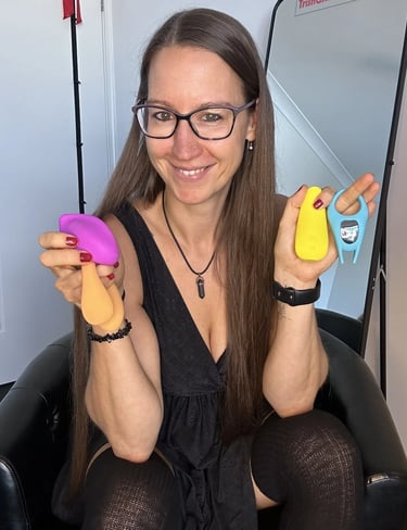 Pleasurelit Patricia holding the moment condoms pleasure toys. 