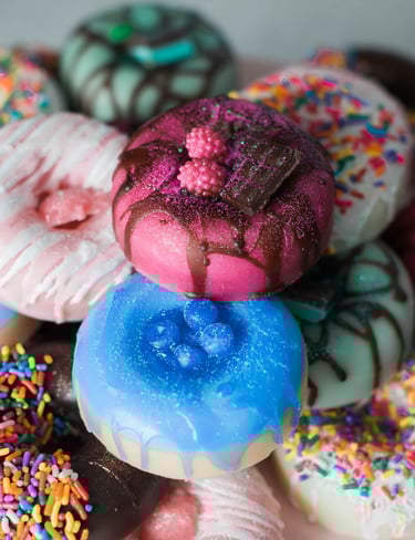 a plate with a bunch of donut soaps on it