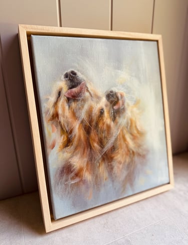 An original oil painting of golden retrievers, framed in a natural wood float frame 