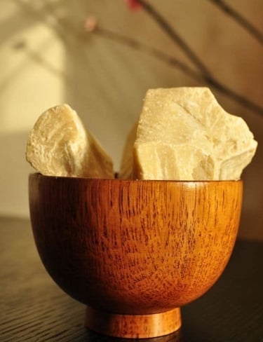 Pure Natural Cocoa Butter Blocks in a Wooden Bowl by Cocoa Prime