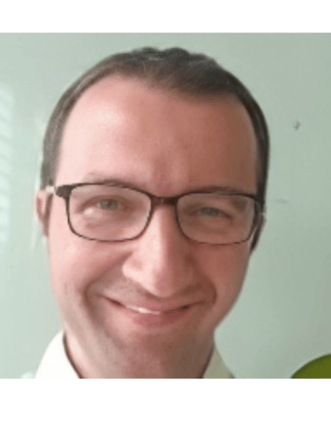a man with glasses and a white shirt
