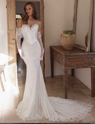 a woman in a white dress with a long sleeved dress