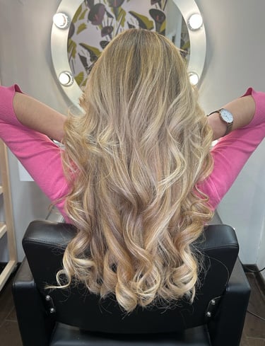 a woman with blonde hair and a pink top