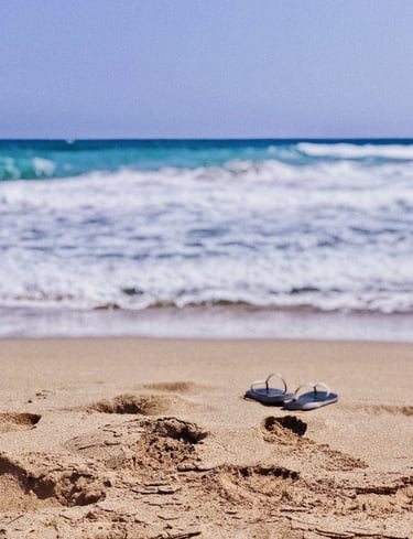 a pair of flip flop on the beach